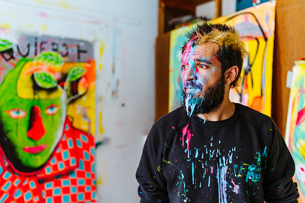 istock Thoughtful Artist with a Paint-Covered Face in His Studio 2205559438