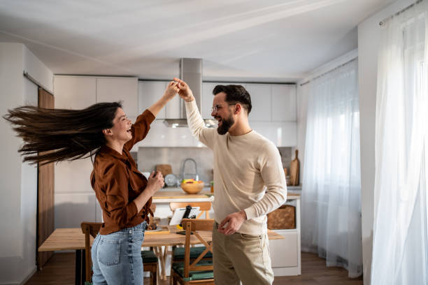 istock Happy couple dancing and having fun in the kitchen 2205559673