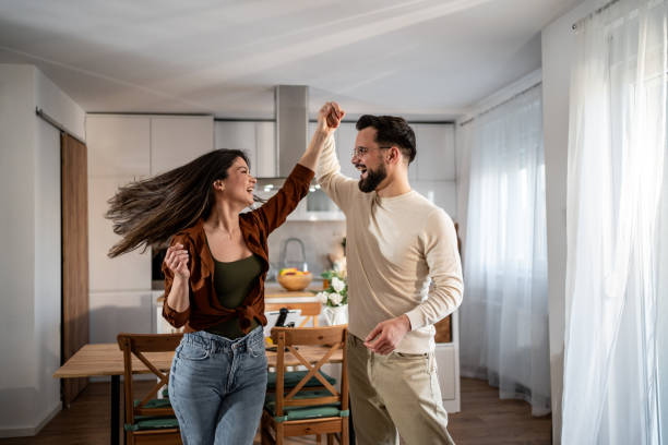 istock Happy couple dancing and having fun in their modern kitchen 2205559678