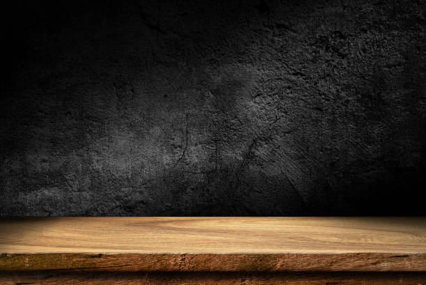 istock Wooden table in dark room background 2205562814