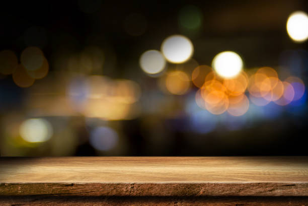 istock wooden table top on blur light golden 2205562851
