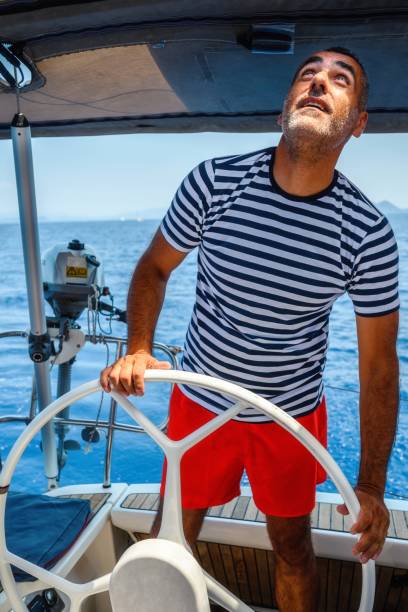 istock Man is driving a sailboat and enjoying it. 2205567337