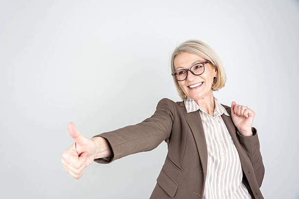 istock Businesswoman pointing fingers up at empty copy space 2205568040