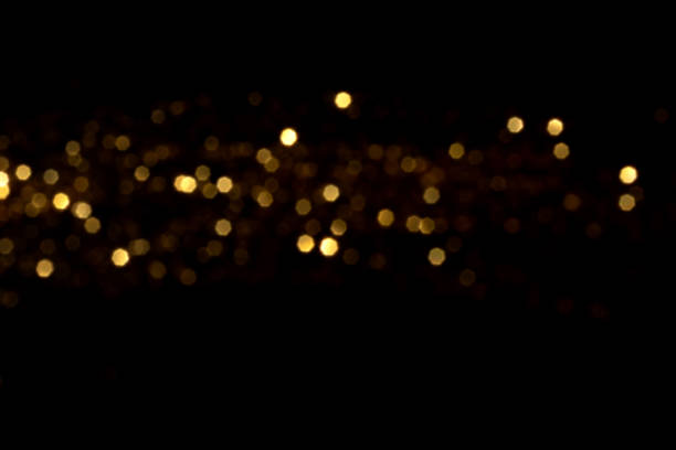 istock Golden blurred bokeh lights on black background 2205569243