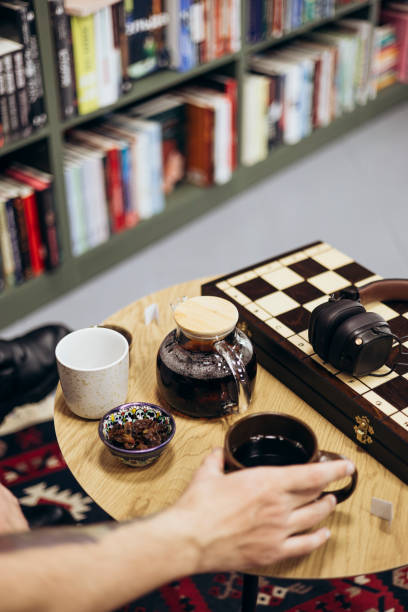 istock Tea and a chessboard on a table in a bookstore cafe. 2205571973