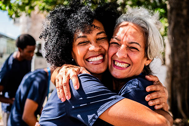 istock Volunteer friends embraced outdoors 2205572072