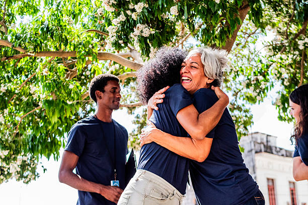 istock Volunteer friends embraced outdoors 2205572120