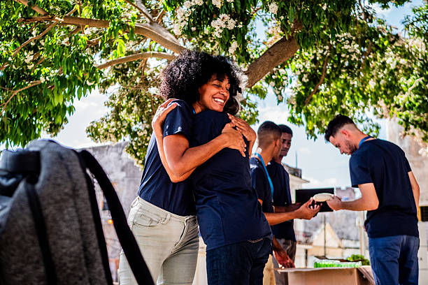 istock Volunteer friends embraced outdoors 2205572267