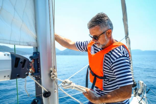 istock Mature man on sailboat 2205572596