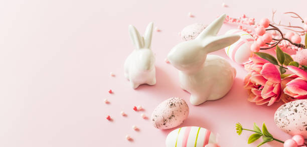 istock Easter bunnies and eggs on a pink background 2205572603