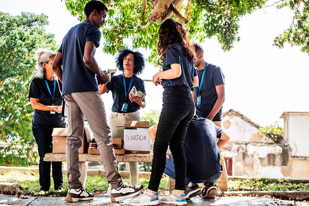 istock Volunteers talking and organizing donation boxes outdoors 2205572907
