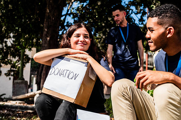 Volunteers talking and holding donation boxes outdoors