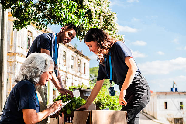 istock Volunteers organizing donation boxes outdoors 2205573022