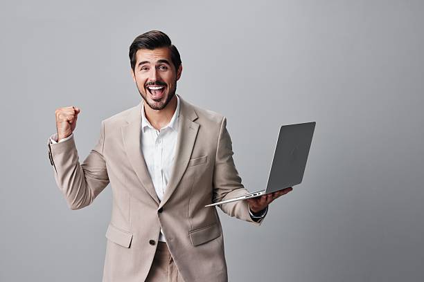 istock freelancer man smiling business suit copyspace person laptop computer job internet 2205573647