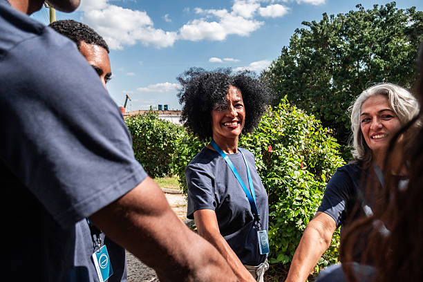 istock Volunteers with hands togethers outdoors 2205574552