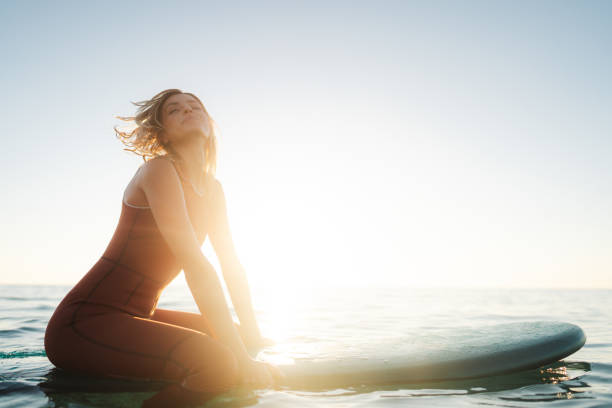 istock Surfer girl and her surfboard 2205574765