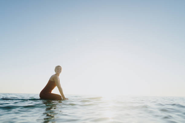 istock Surfer girl and her surfboard 2205574780