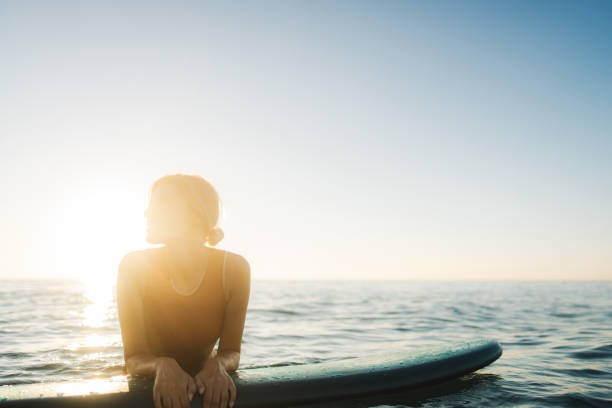 istock Surfer girl and her surfboard 2205574793