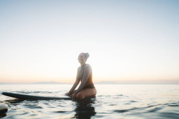 istock Surfer girl in the ocean 2205574832