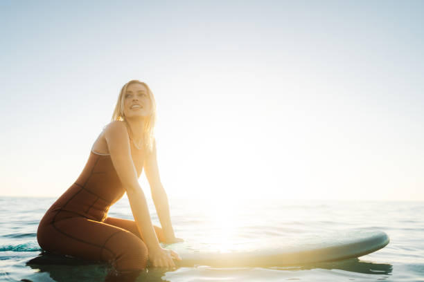 istock Surfer girl and her surfboard 2205574843