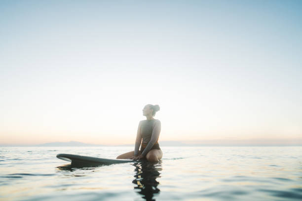 istock Surfer girl in the ocean 2205574845