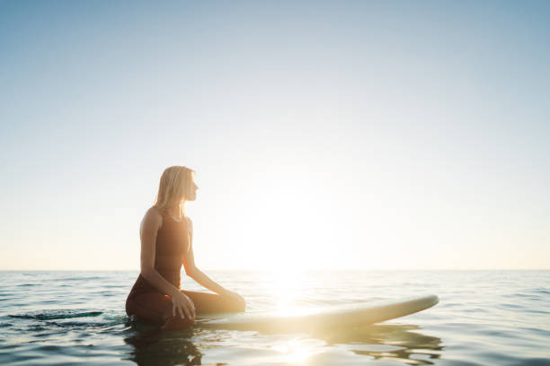 istock Surfer girl and her surfboard 2205574866