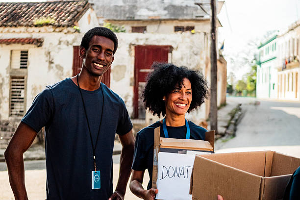 istock Volunteers with donation box outdoors 2205575280
