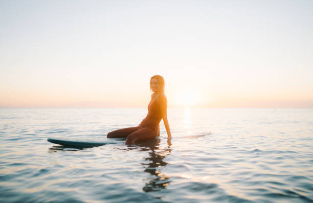 istock Surfer girl and her surfboard 2205575367
