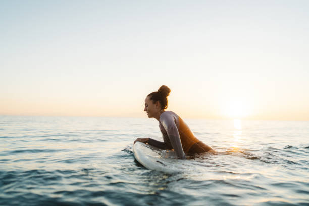 istock Surfer girl in the ocean 2205575377