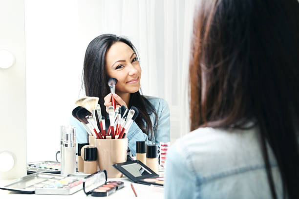 istock Beautiful young woman making make-up 2205576085