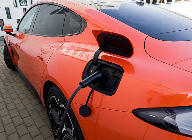 Minsk, Belarus, March 17, 2025 - Close-up modern Xiaomi SU7 electric car parked charging at public power station. Luxury chinese electric vehicle