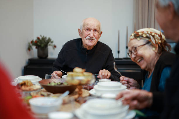 Happy Muslim family having iftar dinner together in the kitchen. A Muslim Turkish family breaks their fast at the iftar table. Iftar is the evening meal at which Muslims