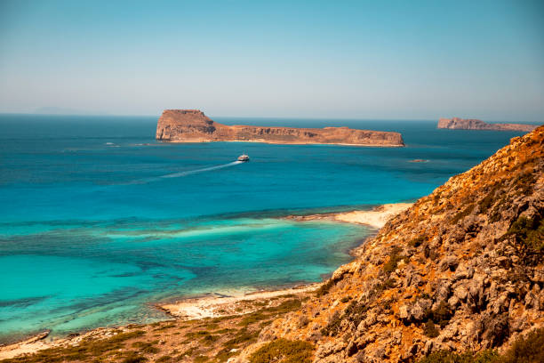 Awesome landscape of a rocky hill, Balos beach with fantastic white sand and three seas: Ionian, Aegean and Libyan