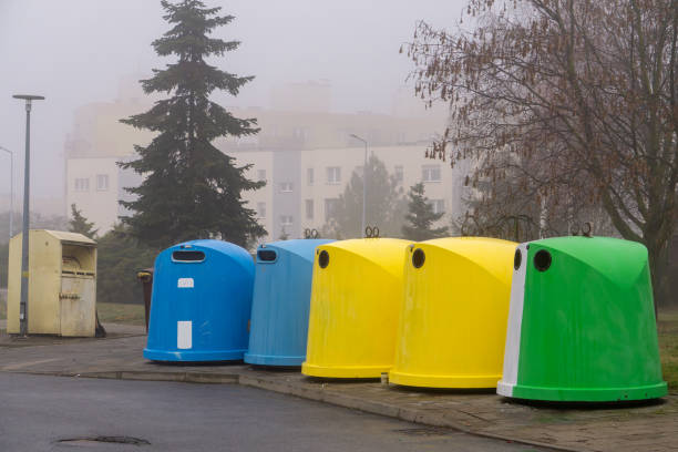 istock multi-colored large garbage cans in a residential area in the city. waste segregation. 2205581121