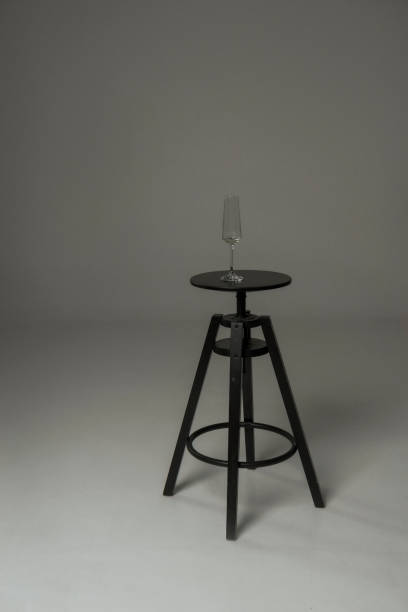 istock black chair in the studio and a transparent glass on it. 2205581131