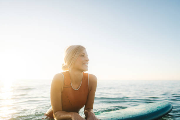 istock Surfer girl and her surfboard 2205581819