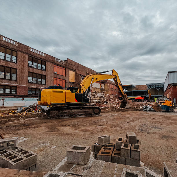 Closeup Excavator at demolition site, side view, background with copy space, full frame horizontal composition