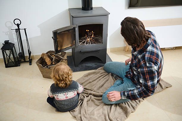 istock Father and Child Bonding by a Cozy Fireplace in a Warm Home 2205584247