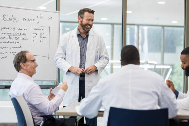 istock Healthcare Team Meeting: Doctor Explains Case Study 2205584529