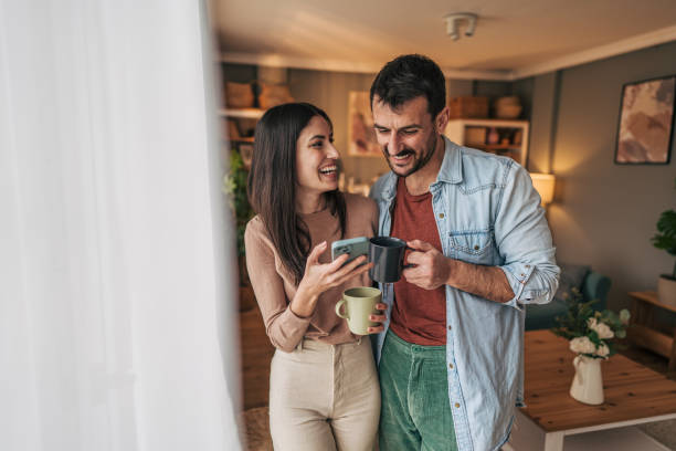 istock Young couple laughing and sharing a moment at home 2205586653