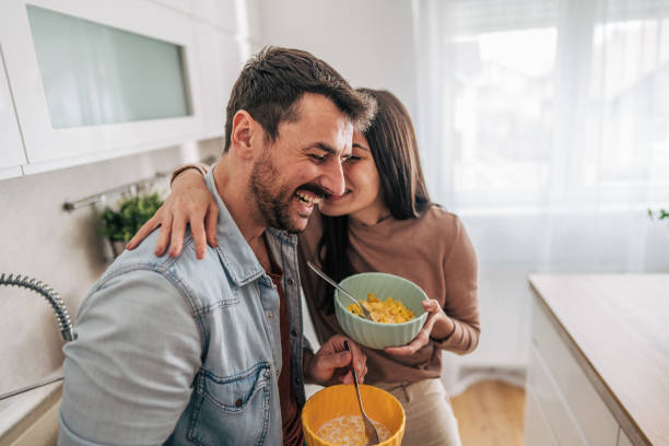 istock Happy couple enjoying breakfast and sharing a tender moment in the kitchen 2205586841