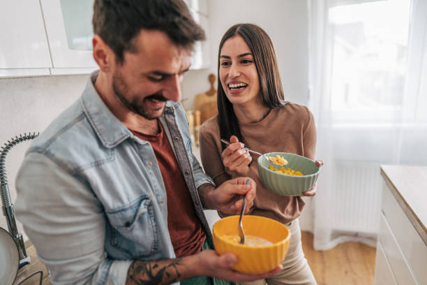 istock Cheerful couple enjoying breakfast together in modern kitchen 2205586843