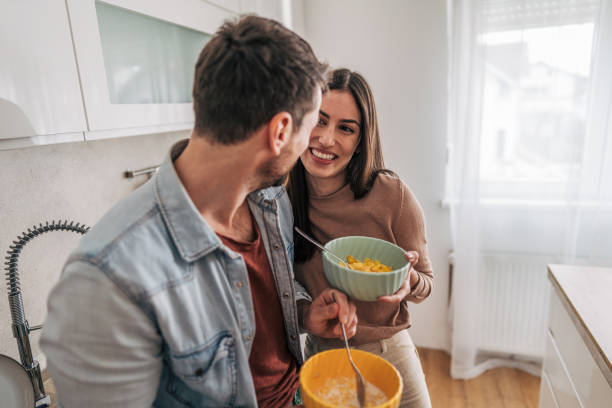 istock Happy couple enjoying breakfast together in modern kitchen 2205586883