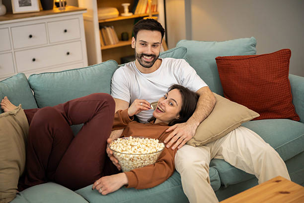 istock Relaxing Couple Enjoying Movie Night 2205587638