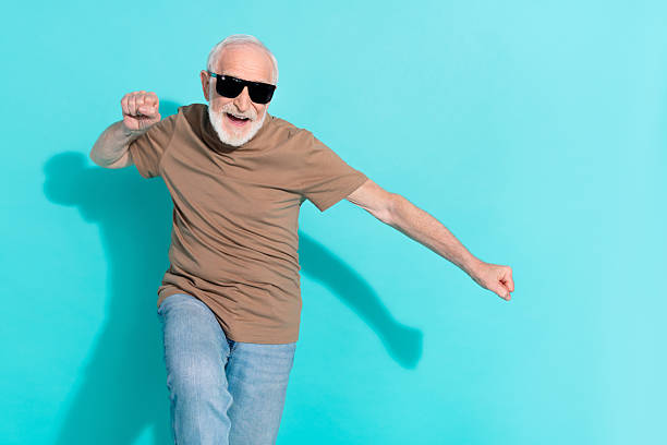 istock Portrait of attractive cheerful grey-haired man dancing having fun rest isolated over bright blue color background 2205588884