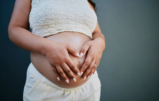 istock Expectant Mother Embracing Pregnancy with Love 2205589547