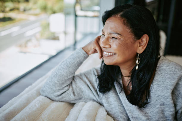istock Thoughtful Mature Woman Gazing Out a Window 2205590214