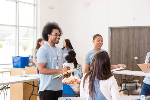 istock Diverse Group of Volunteers Working Together at a Community Event 2205590261