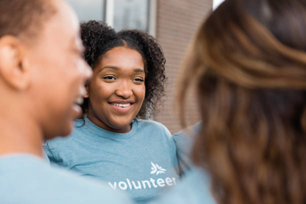 istock Smiling young woman volunteer in a group discussion 2205590341
