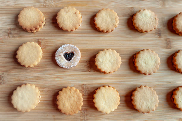 Stock photo showing close-up view of oven baking tray containing a freshly baked batch of homemade, double chocolate chip biscuits and shortcake rounds, home baking concept.*Not AI modified*
